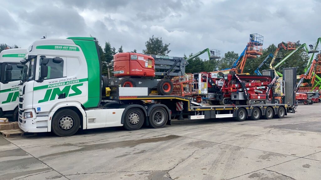 Hinowa spider lift and Skujack boom lift loaded on truck for delivery